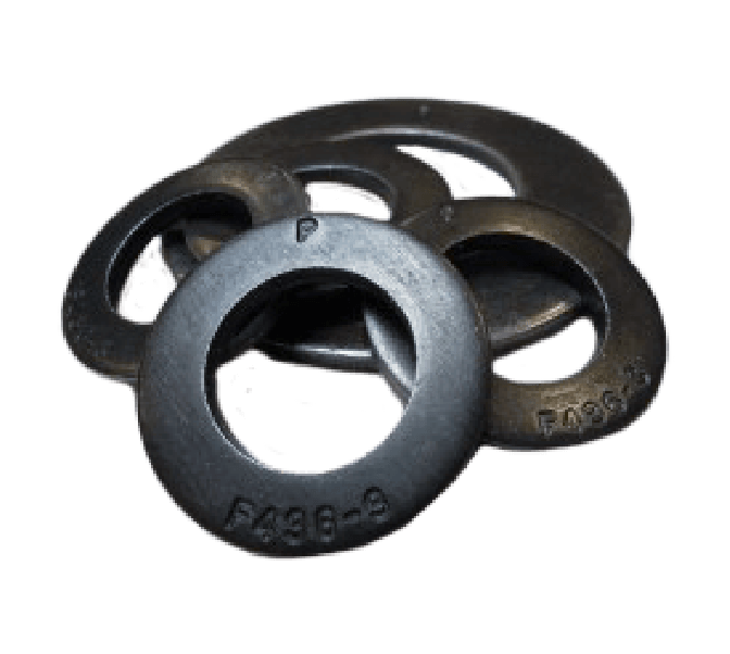 Four black, circular metal washers with central holes and markings are stacked together on a plain background.